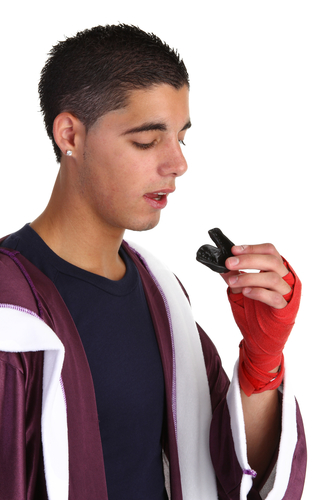 boxing guy putting a mouth guard in