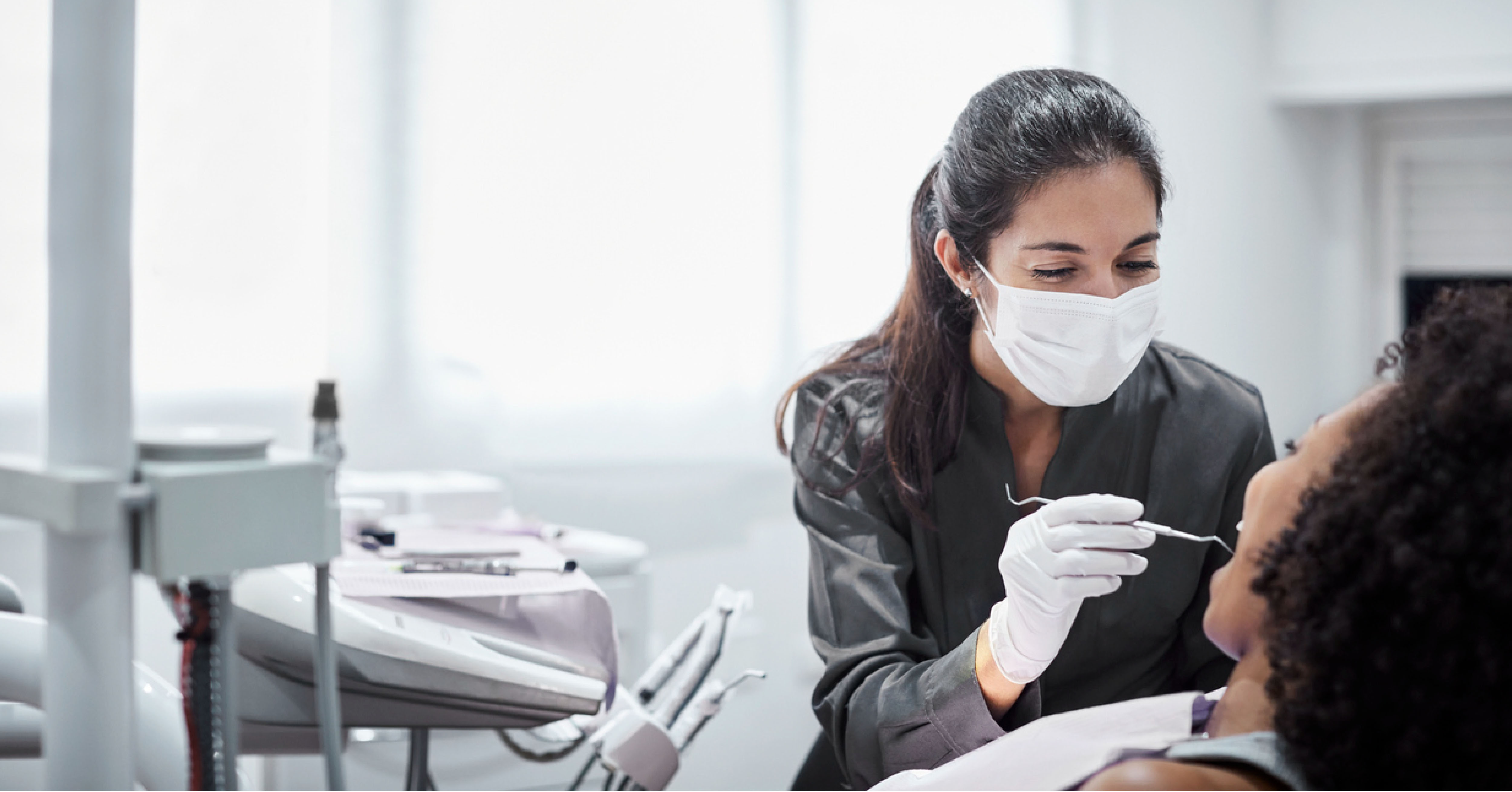 dentist cleaning patients teeth